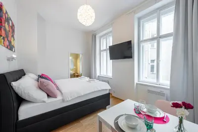 a living room with a couch and a table at Residence Tesnov Apartment in Prague