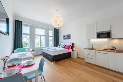 a living room with a bed and a table at Residence Tesnov Apartment in Prague