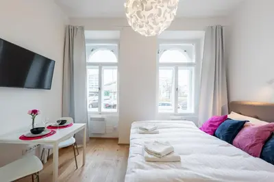 a bedroom with a bed and a table and a tv at Residence Tesnov Apartment in Prague