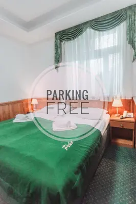 a bedroom with a green bed with the words parking free at Hotel Peko in Prague