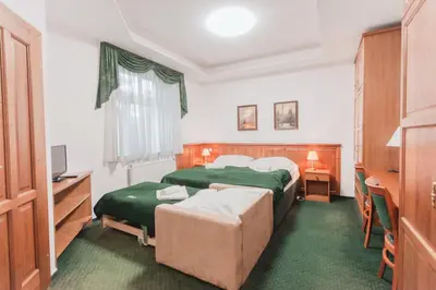 a hospital room with two beds and a television at Hotel Peko in Prague