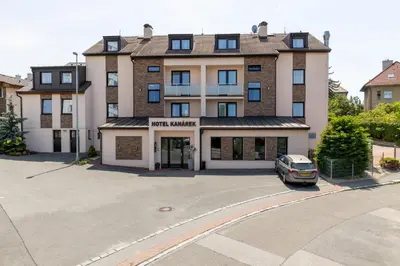 a building with a car parked in front of it at Hotel Kanarek in Prague