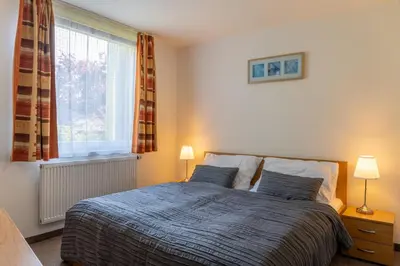 a bedroom with a bed with two pillows and a window at Hotel Kanarek in Prague