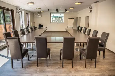 a conference room with a long table and chairs at Hotel Kanarek in Prague