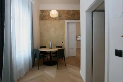 a dining room with a table and chairs at The Apartment House - Mezibranska in Prague
