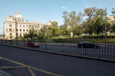 a car driving down a road in front of a building at The Apartment House - Mezibranska in Prague
