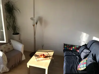 a living room with a couch and a table at Cosy Flora Nest in Prague