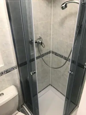 a shower with a glass door in a bathroom at Cosy Flora Nest in Prague