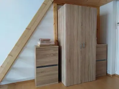 a room with a book shelf and a closet at Studio Husitská 114/74 in Prague