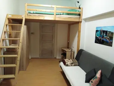 a living room with a bunk bed and a couch at Studio Husitská 114/74 in Prague