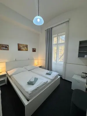 a bedroom with a white bed and a window at Welcome Hostel & Apartments Praguecentre in Prague
