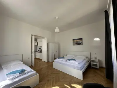 two white beds in a room with a window at Welcome Hostel & Apartments Praguecentre in Prague