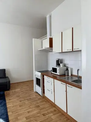 two beds in a room with white walls and wooden floors at Welcome Hostel & Apartments Praguecentre in Prague