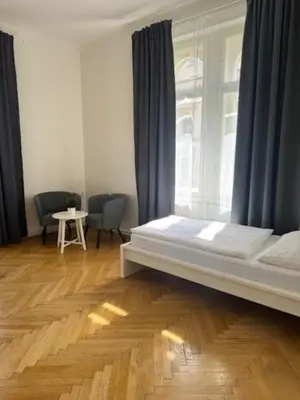 a bedroom with a white bed and a window at Welcome Hostel & Apartments Praguecentre in Prague