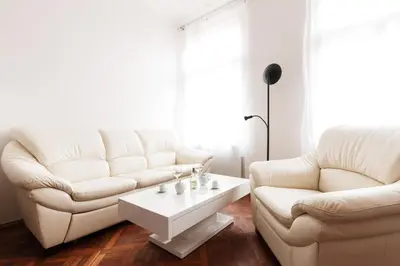 a living room with two white couches and a coffee table at Prague Days - Spacious Retro-vibes Apartment near Charles Square in Prague