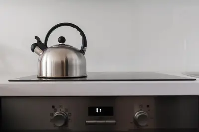 a tea kettle sitting on top of a stove at Prague Days - Spacious Retro-vibes Apartment near Charles Square in Prague