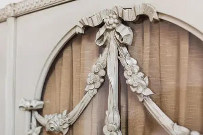 a white cross with flowers on a window curtain at Prague Days - Spacious Retro-vibes Apartment near Charles Square in Prague