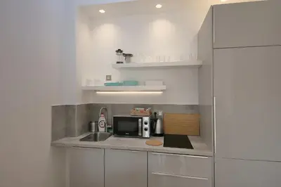 a small kitchen with a sink and a microwave at Prague Expat House in Prague