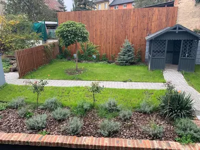 a backyard with a garden with a fence at Prague Expat House in Prague
