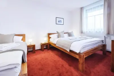 a bedroom with two beds and a window at Penzion Al Capone Mníšek in Mníšek pod Brdy