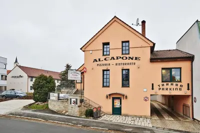 a building with a sign that reads algarve therapeutic architecture at Penzion Al Capone Mníšek in Mníšek pod Brdy