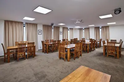 a dining room with wooden tables and chairs at Penzion Al Capone Mníšek in Mníšek pod Brdy