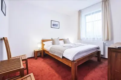 a bedroom with a bed and a window at Penzion Al Capone Mníšek in Mníšek pod Brdy