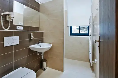 a bathroom with a white toilet and a sink at Penzion Al Capone Mníšek in Mníšek pod Brdy