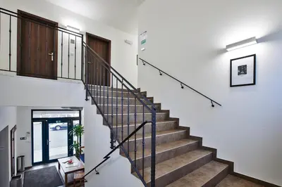 a staircase in a home with white walls and a stair case at Penzion Al Capone Mníšek in Mníšek pod Brdy