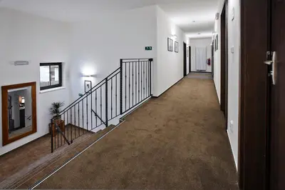 an empty hallway with a staircase in a house at Penzion Al Capone Mníšek in Mníšek pod Brdy