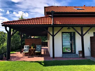 a covered patio with two chairs and a table at Garden studio apt-FREE parking,close D8,metro,EXPO in Hovorčovice