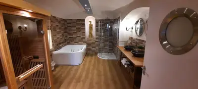 a bathroom with a tub and a sink and a mirror at Excellent Romantic in Prague