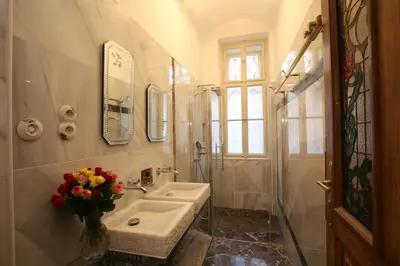 a bathroom with a sink and a mirror at Apartman Dalia Janáčkovo nábřeží in Prague
