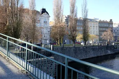 a bridge over a river with buildings in the background at Apartman Dalia Janáčkovo nábřeží in Prague