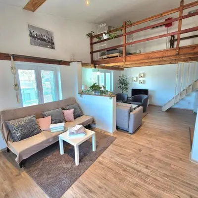 a living room with a couch and a table at Apartmán ,,Rokytka