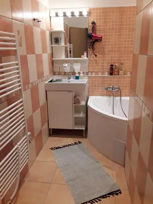 a small bathroom with a tub and a sink at Apartmán ,,Rokytka