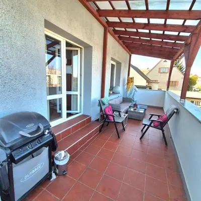 a screened in porch with a grill on a house at Apartmán ,,Rokytka