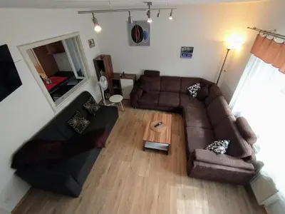 a living room with a couch and a table at Duplex with garden in Prague