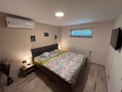 a bedroom with a bed and a television in it at Apartments Praha Jinonice in Prague