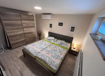 a small bedroom with a bed in a room at Apartments Praha Jinonice in Prague