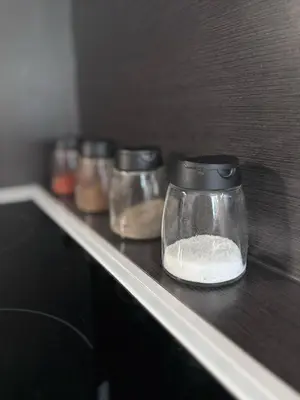 a row of glass jars on a shelf at Apartments Praha Jinonice in Prague
