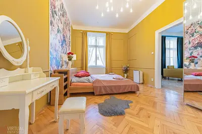 a bedroom with a bed and a mirror at Colorful Wenceslas square apartment in Prague