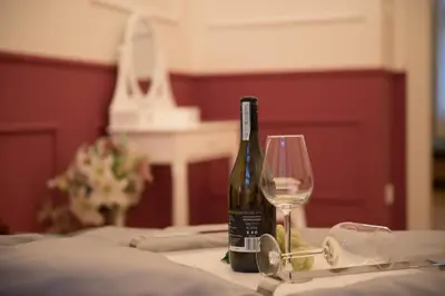a bottle of wine sitting on a table with a glass at Colorful Wenceslas square apartment in Prague
