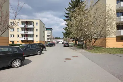 a street with cars parked on the side of the road at Richie Apartment near Aquapark in Prague