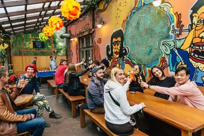 a group of people sitting at tables in a restaurant at Hostel Elf in Prague