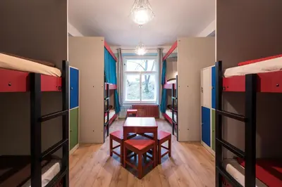 a room with several bunk beds and a table at Hostel Elf in Prague