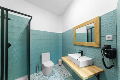 a bathroom with a sink and a mirror and a toilet at Hostel Elf in Prague