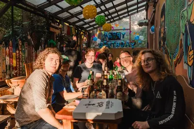 a group of people sitting at a table in a bar at Hostel Elf in Prague