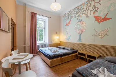 a room with a bed and a table in it at Hostel Elf in Prague