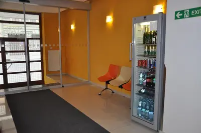 a room with a refrigerator and a chair in it at City Central De Luxe in Prague